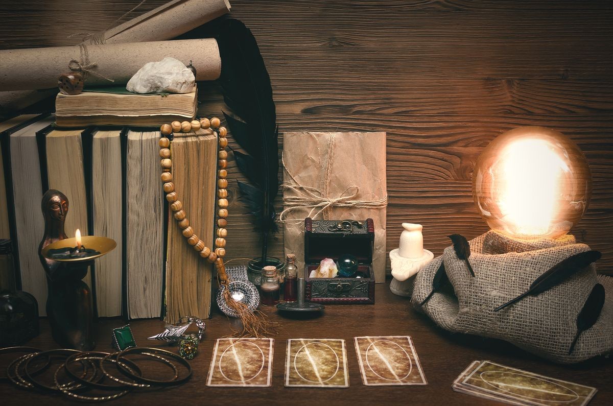 Crystal ball and tarot cards on fortune teller desk. Future reading concept. Paranormal magic table.